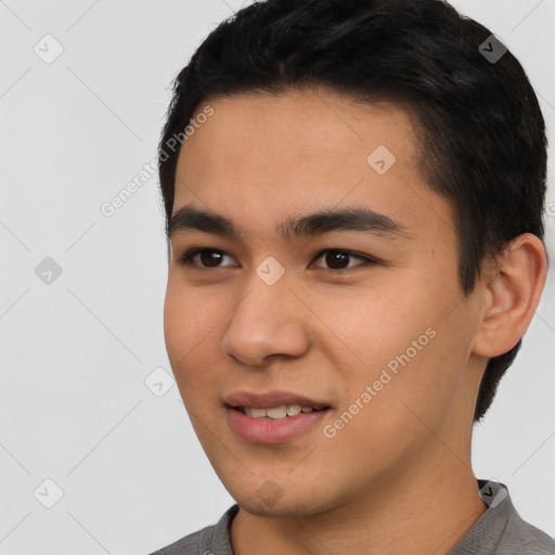 Joyful asian young-adult male with short  black hair and brown eyes