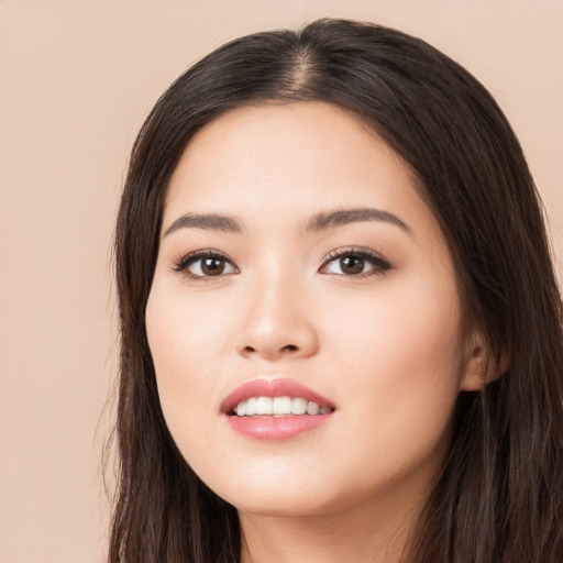 Joyful asian young-adult female with long  brown hair and brown eyes