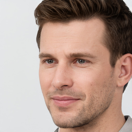 Joyful white adult male with short  brown hair and grey eyes