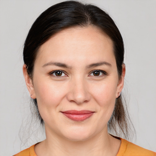 Joyful white young-adult female with medium  brown hair and brown eyes