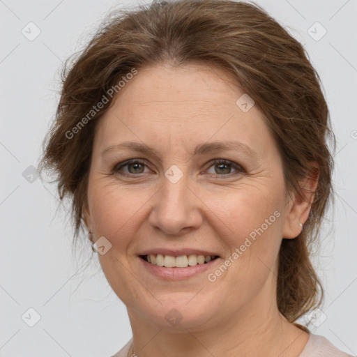 Joyful white adult female with medium  brown hair and grey eyes