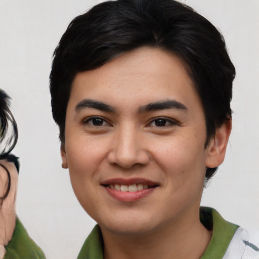 Joyful asian young-adult male with medium  black hair and brown eyes