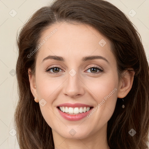 Joyful white young-adult female with long  brown hair and green eyes