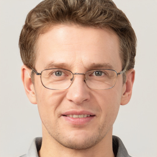 Joyful white adult male with short  brown hair and grey eyes