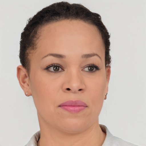Joyful latino young-adult female with short  brown hair and brown eyes