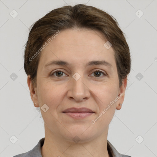 Joyful white adult female with short  brown hair and grey eyes