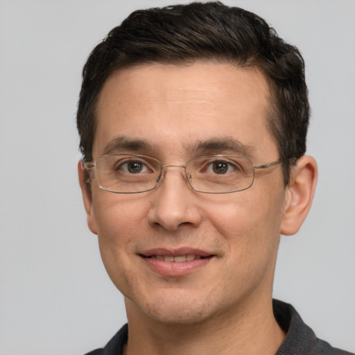 Joyful white adult male with short  brown hair and brown eyes