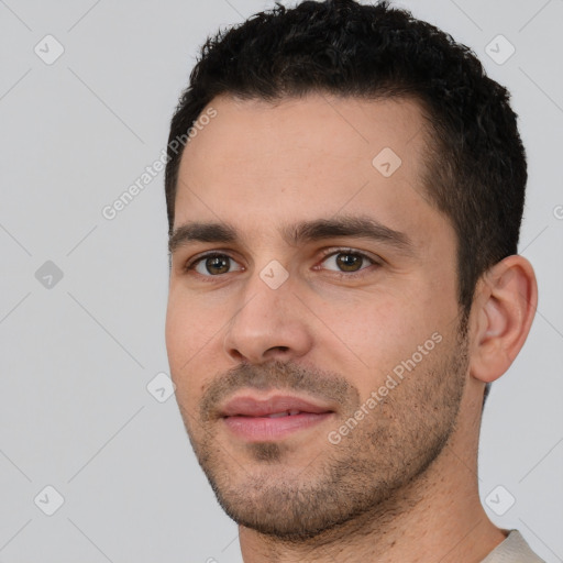 Joyful white young-adult male with short  black hair and brown eyes