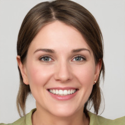 Joyful white young-adult female with medium  brown hair and grey eyes