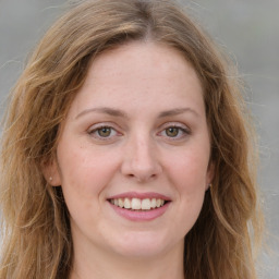 Joyful white young-adult female with long  brown hair and green eyes