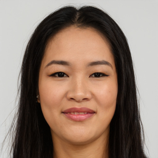 Joyful asian young-adult female with long  brown hair and brown eyes