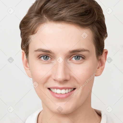 Joyful white young-adult female with short  brown hair and grey eyes