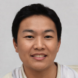 Joyful asian young-adult male with short  black hair and brown eyes