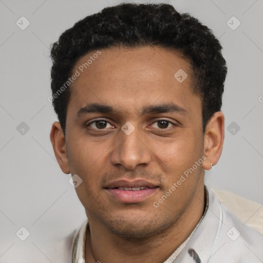 Joyful black young-adult male with short  black hair and brown eyes