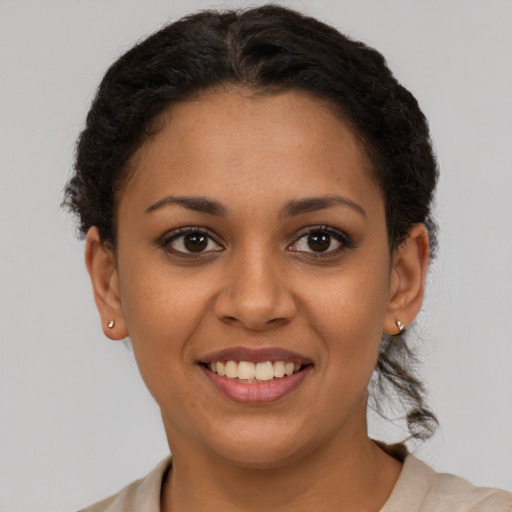 Joyful latino young-adult female with short  brown hair and brown eyes