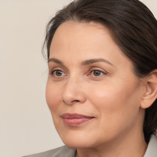 Joyful white adult female with medium  brown hair and brown eyes