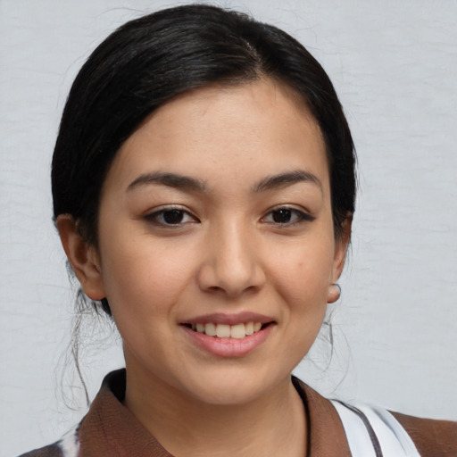 Joyful asian young-adult female with medium  black hair and brown eyes