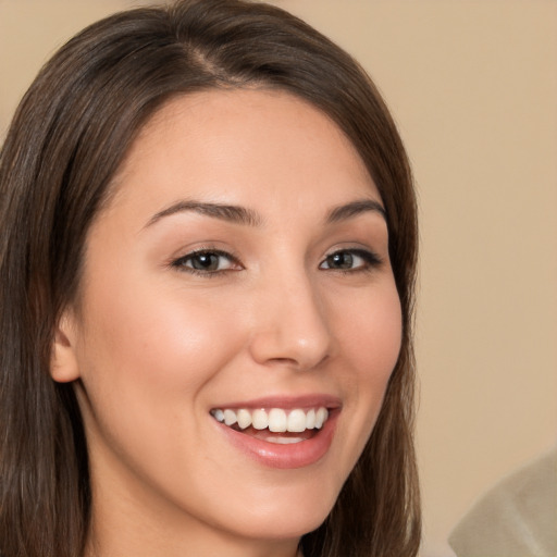 Joyful white young-adult female with long  brown hair and brown eyes