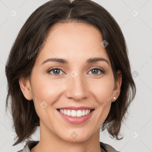 Joyful white young-adult female with medium  brown hair and grey eyes