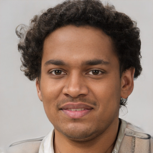 Joyful black young-adult male with short  brown hair and brown eyes