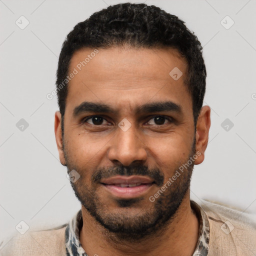 Joyful black young-adult male with short  black hair and brown eyes