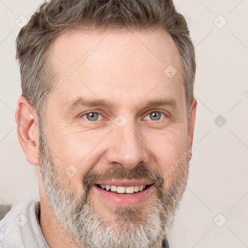 Joyful white adult male with short  brown hair and grey eyes