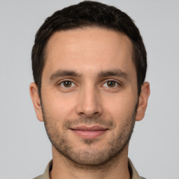 Joyful white young-adult male with short  brown hair and brown eyes