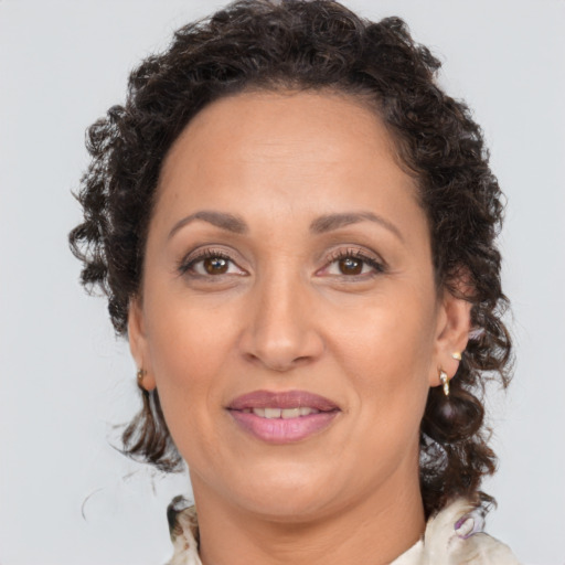 Joyful white adult female with medium  brown hair and brown eyes