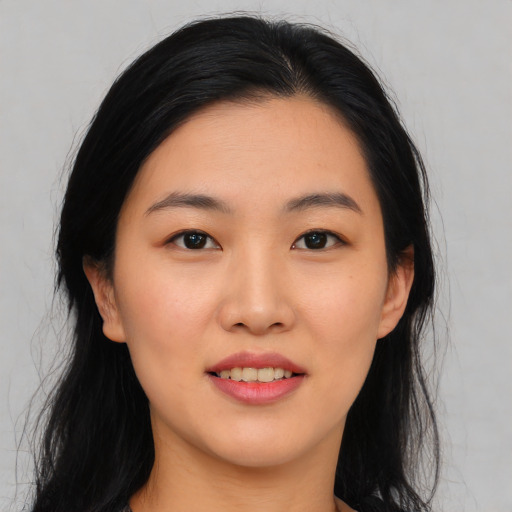 Joyful asian young-adult female with long  black hair and brown eyes