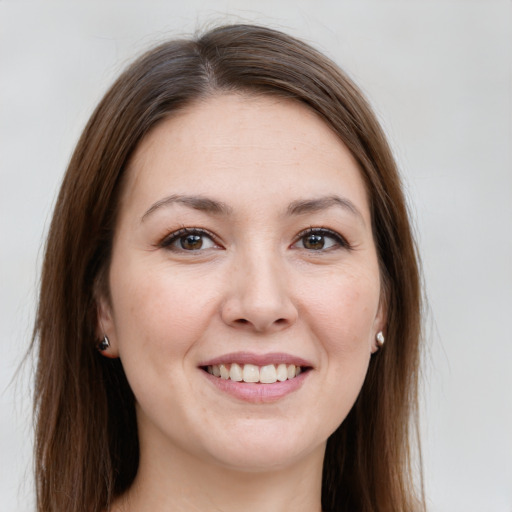 Joyful white young-adult female with long  brown hair and grey eyes