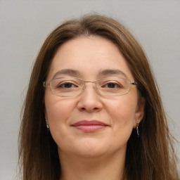 Joyful white adult female with long  brown hair and brown eyes