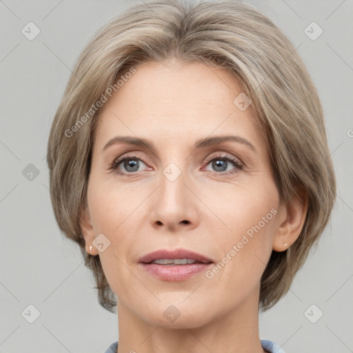 Joyful white adult female with medium  brown hair and grey eyes