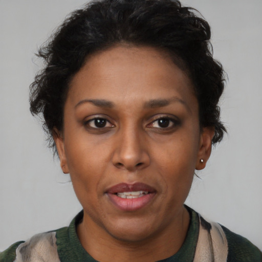 Joyful latino adult female with short  brown hair and brown eyes