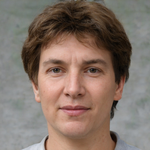 Joyful white adult male with short  brown hair and grey eyes