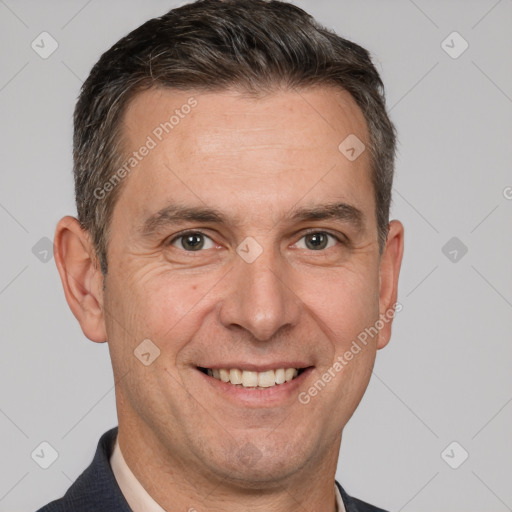 Joyful white adult male with short  brown hair and brown eyes