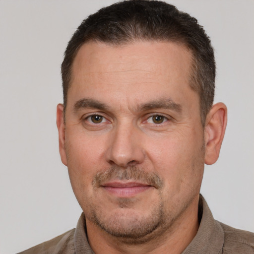 Joyful white adult male with short  brown hair and brown eyes