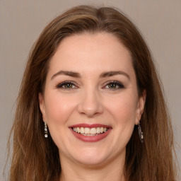 Joyful white young-adult female with long  brown hair and brown eyes