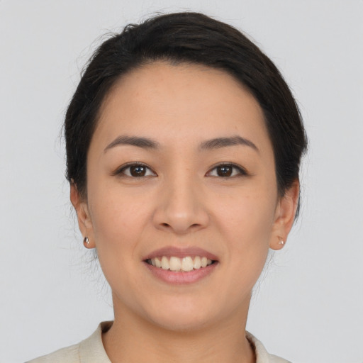 Joyful asian young-adult female with medium  black hair and brown eyes