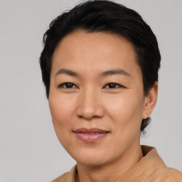 Joyful asian adult female with short  brown hair and brown eyes