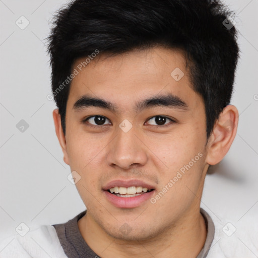 Joyful asian young-adult male with short  brown hair and brown eyes