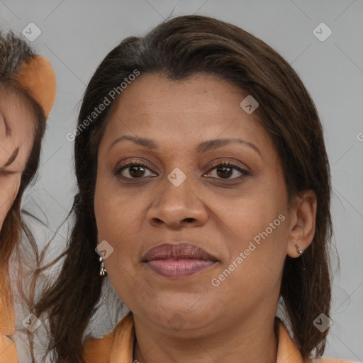 Joyful black adult female with medium  brown hair and brown eyes