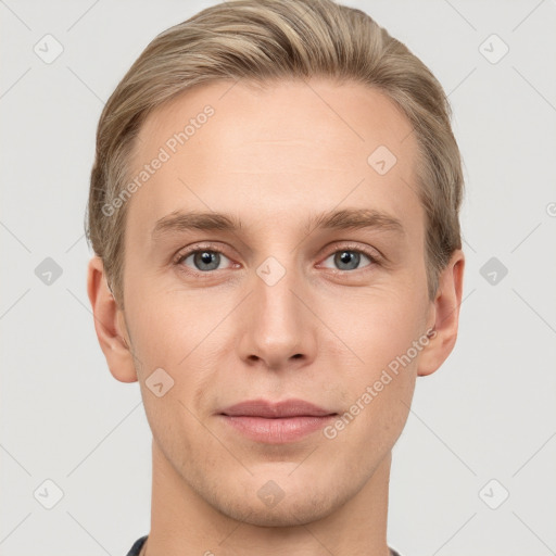 Joyful white young-adult male with short  brown hair and grey eyes