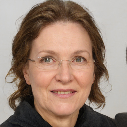 Joyful white middle-aged female with medium  brown hair and grey eyes