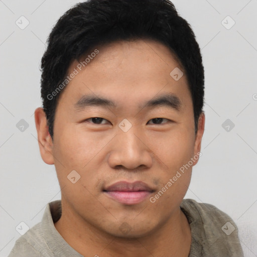 Joyful asian young-adult male with short  black hair and brown eyes