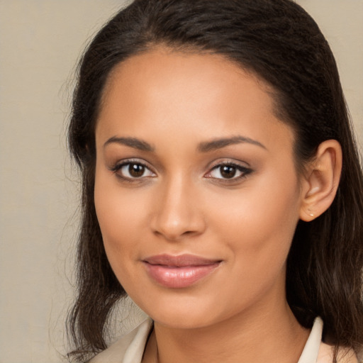 Joyful latino young-adult female with long  brown hair and brown eyes