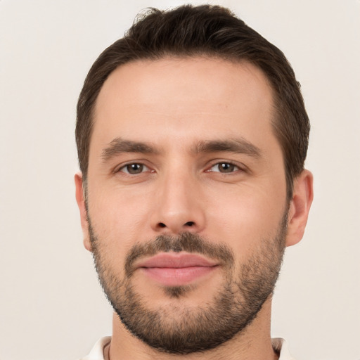 Joyful white young-adult male with short  brown hair and brown eyes