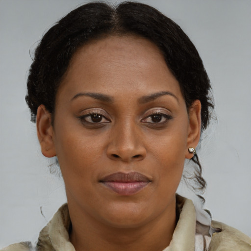 Joyful black young-adult female with medium  brown hair and brown eyes