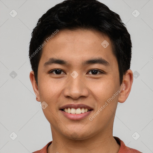 Joyful asian young-adult male with short  black hair and brown eyes