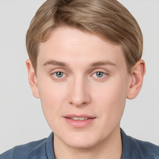 Joyful white young-adult male with short  brown hair and blue eyes