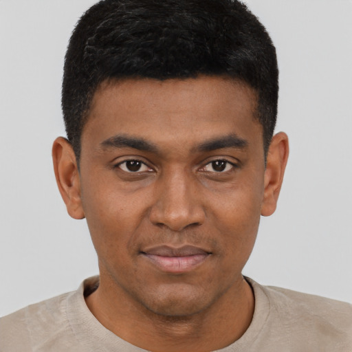 Joyful black young-adult male with short  black hair and brown eyes